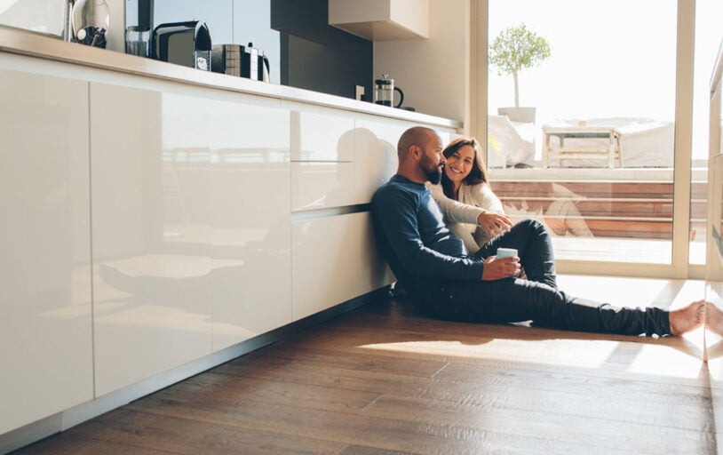 Couple sitting on the floor in kitchen