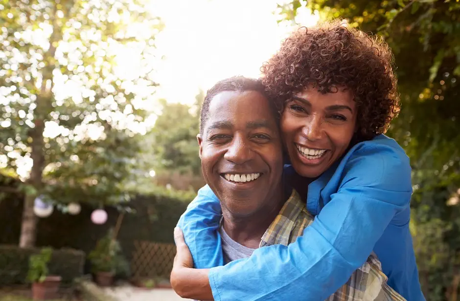 Portrait Of Loving Mature Couple In Back Yard Garden