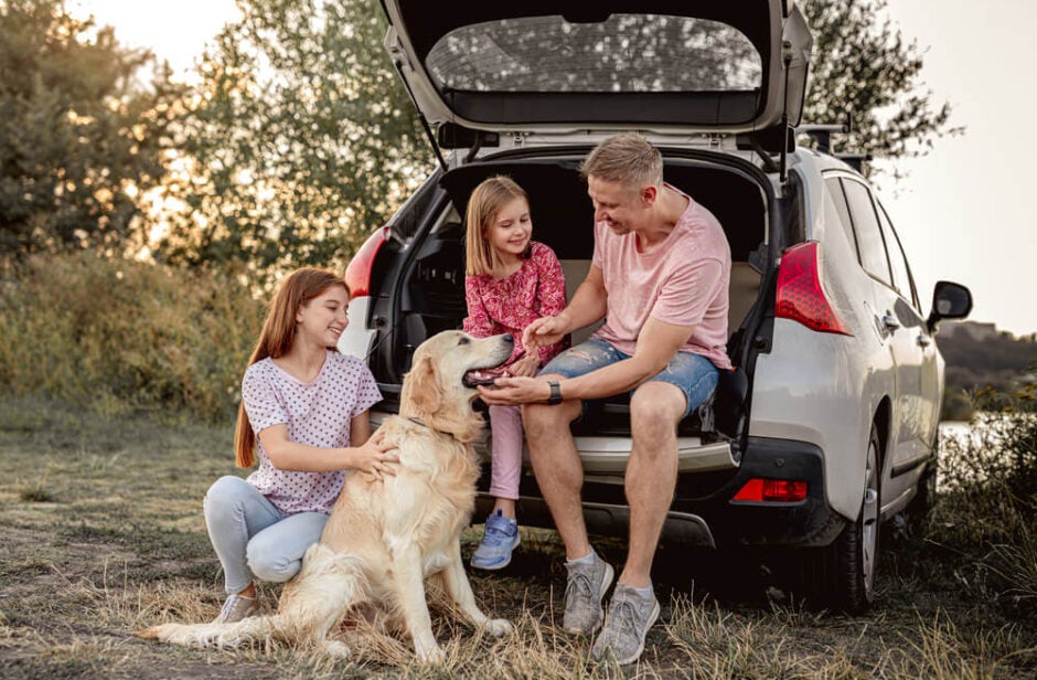 Family Sitting in Trunk of SUV with Dog