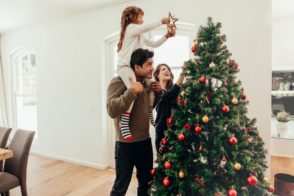 Family putting star on the Christmas tree