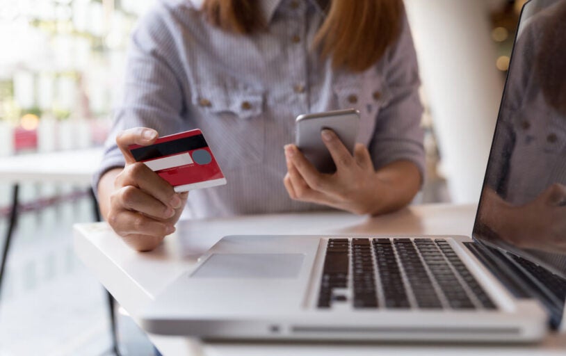 Woman with credit card on laptop