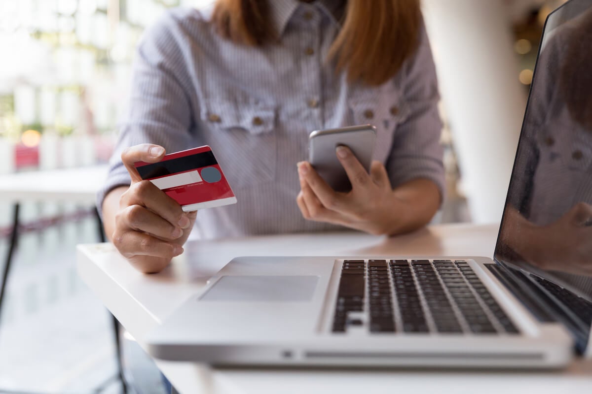 Woman with credit card on laptop