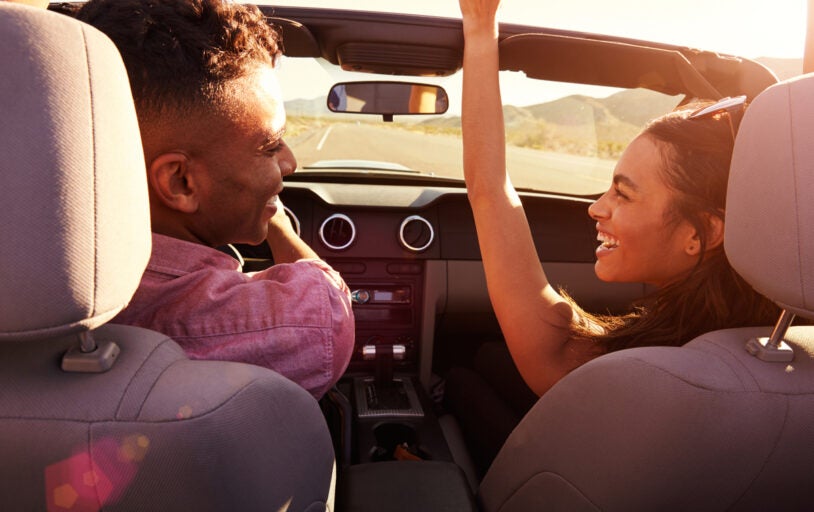 Couple driving in convertible car