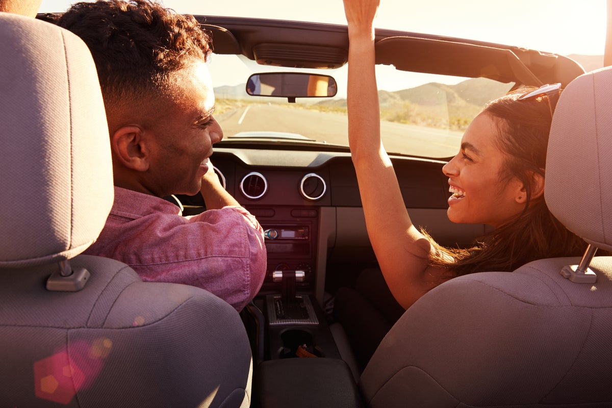 Couple driving in convertible car