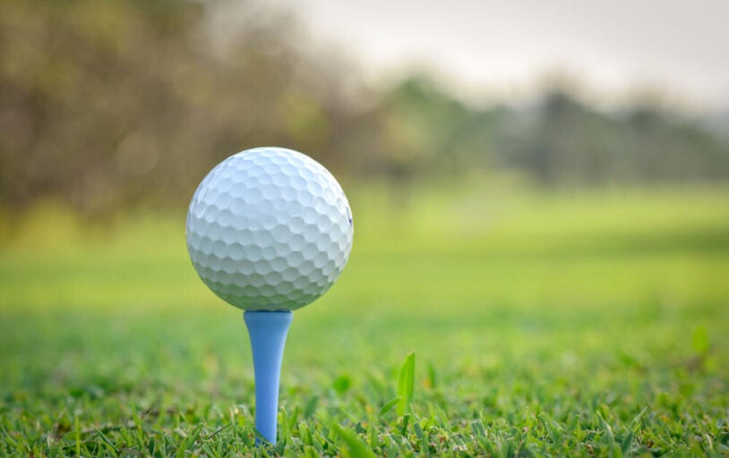 Golf ball of a golf tee on a golf course