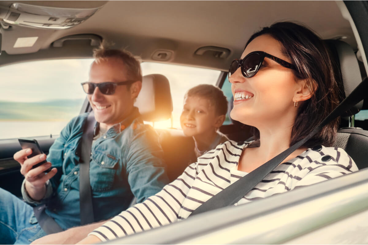 Happy family riding in car