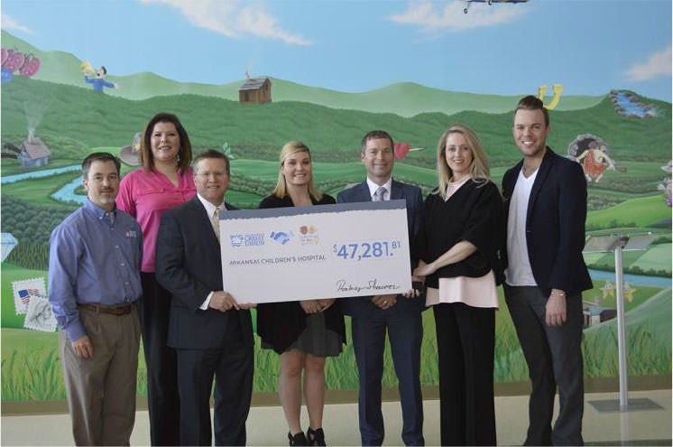 Arkansas Federal Credit Union employees at Arkansas Children's Hospital holding a check for $47,281.81