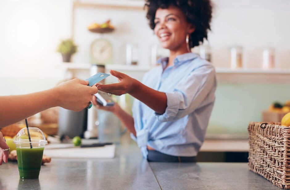 Woman business owner accepting credit card from customer