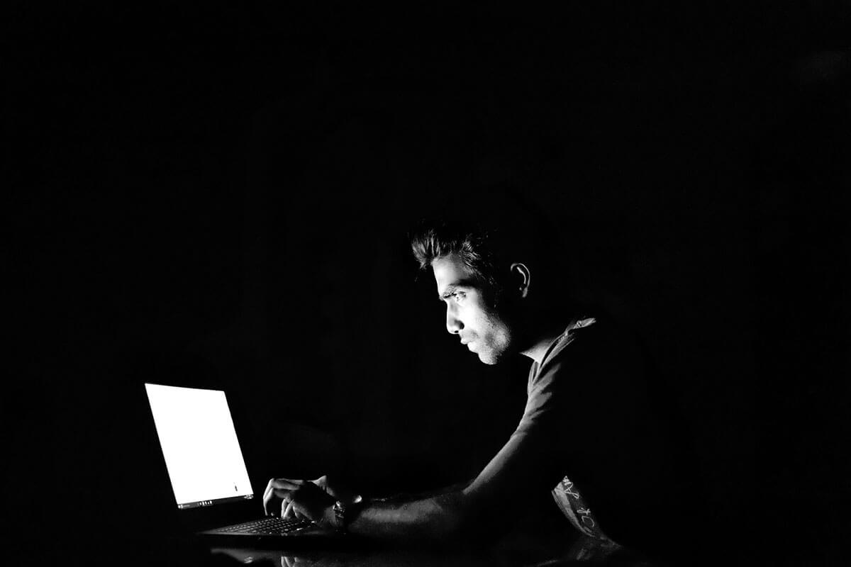 Man on laptop in the dark