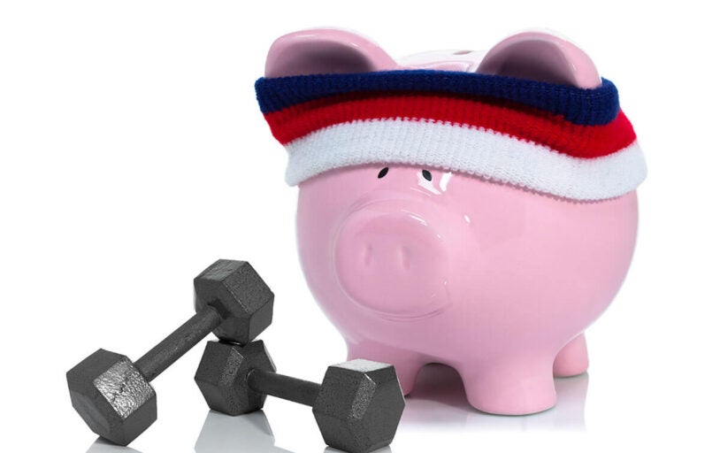 Piggy bank wearing a sweatband with dumbells
