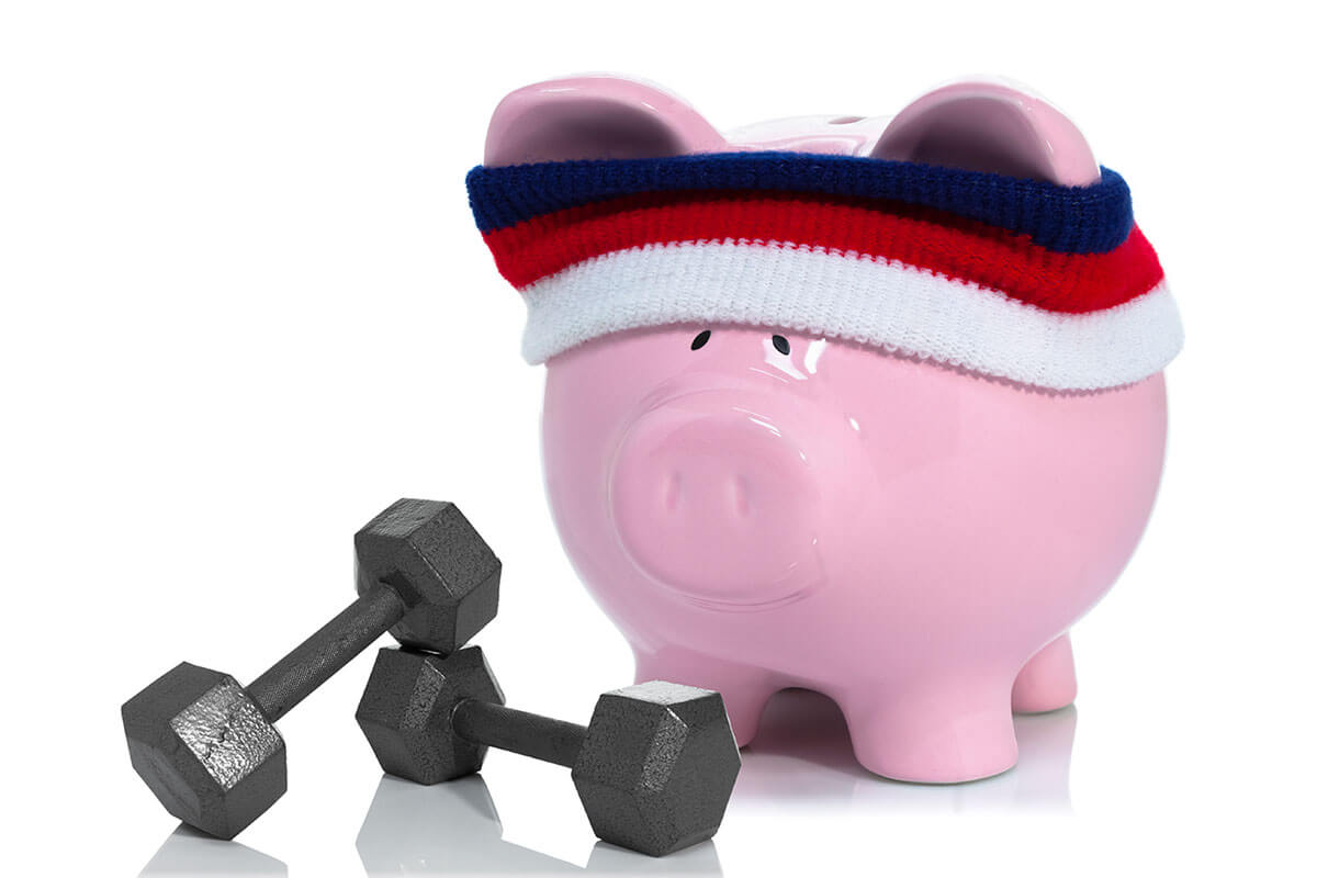 Piggy bank wearing a sweatband with dumbells