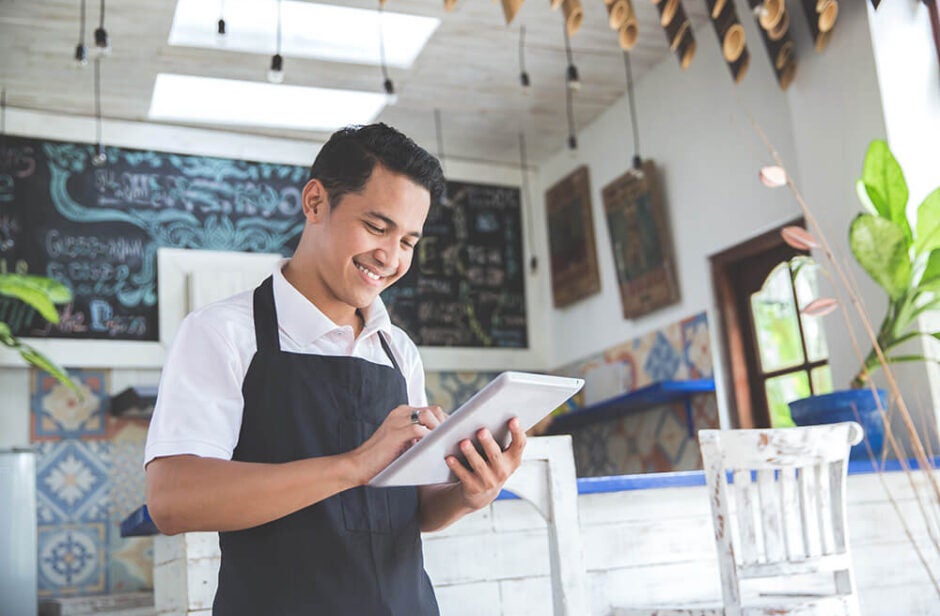 Man using iPad in his storefront