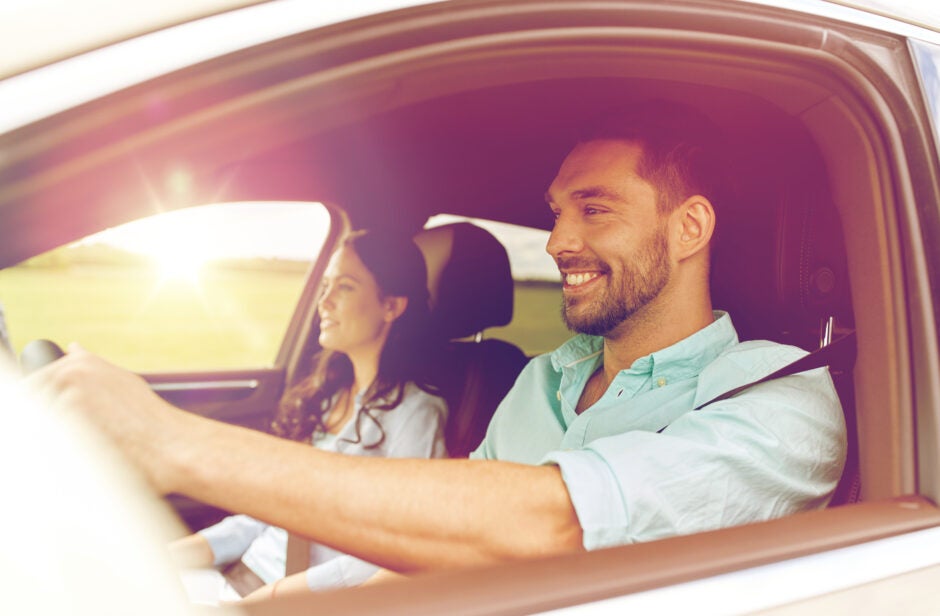 Couple driving around smiling