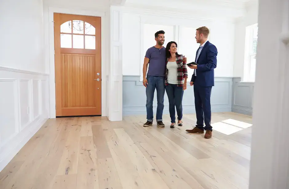 people in a new empty home with a realtor