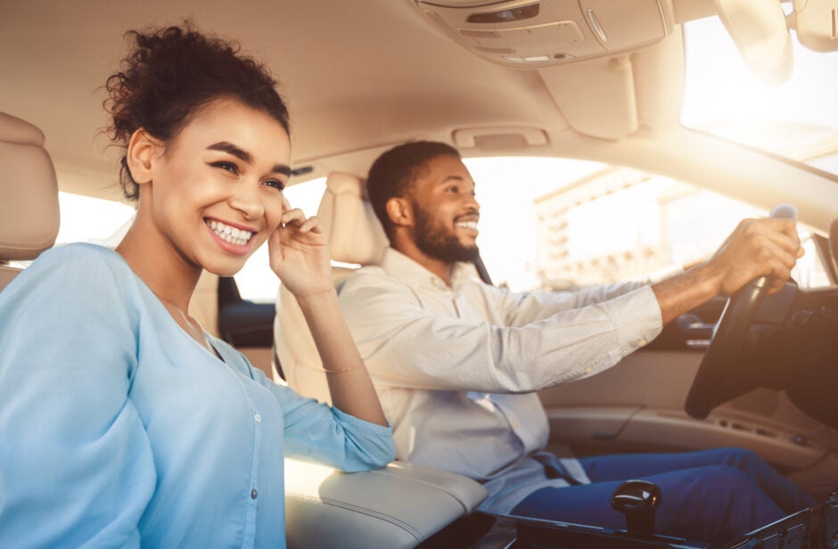 two people driving happily