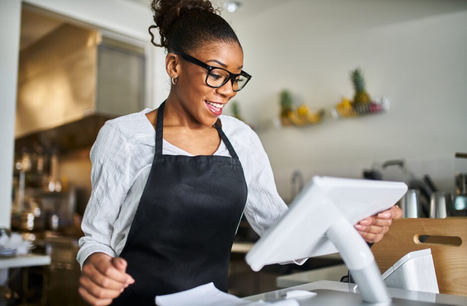 Woman using modern checkout station