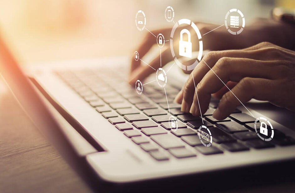 Hands on a laptop keyboard with a lock icon