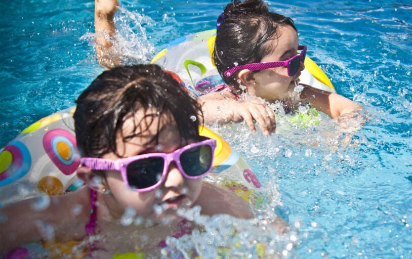 Two kids swimming in a pool