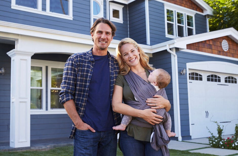 Family in front of new home