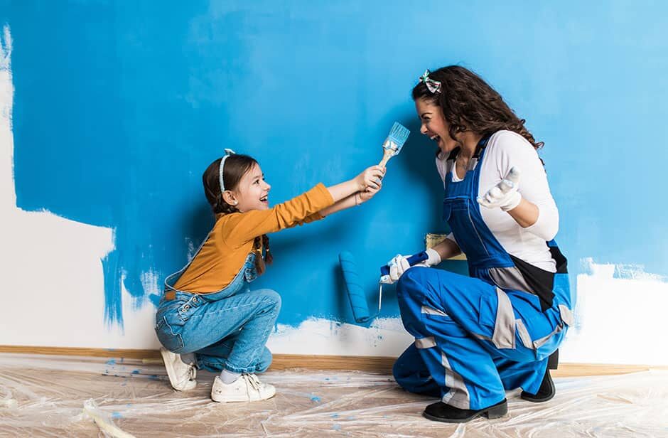 mother and child painting wall, home improvement