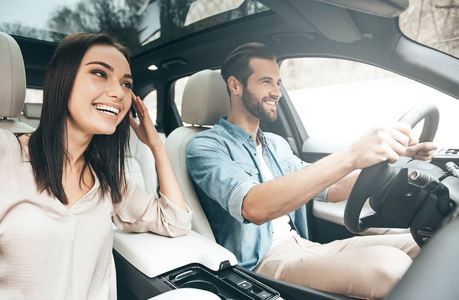 Man driving a car with a woman as a passenger