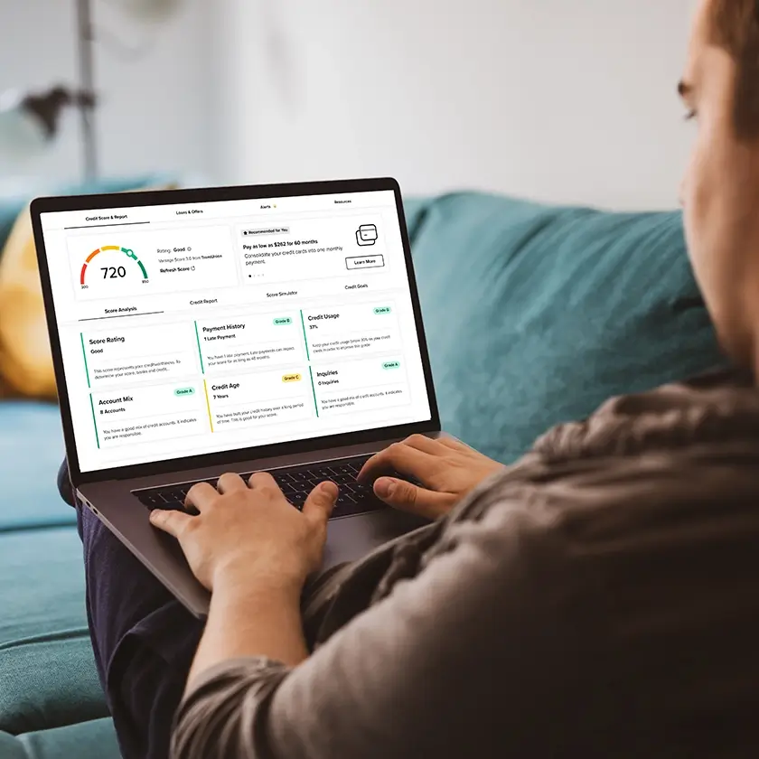 Person using credit IQ on her laptop.