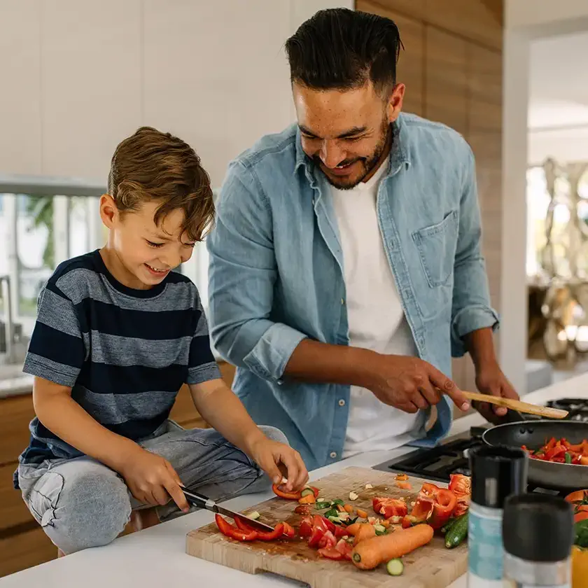 Savings. Father and son cooking dinner.